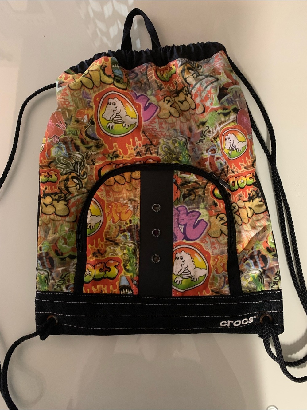 CROCS Multicolor Graffiti Print Drawstring Backpack with Black Trim
